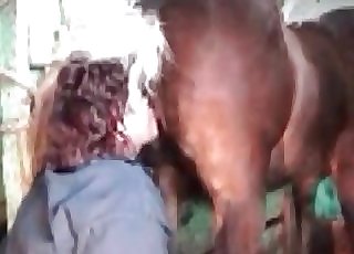 Filthy woman providing a rim job to a handsome horse